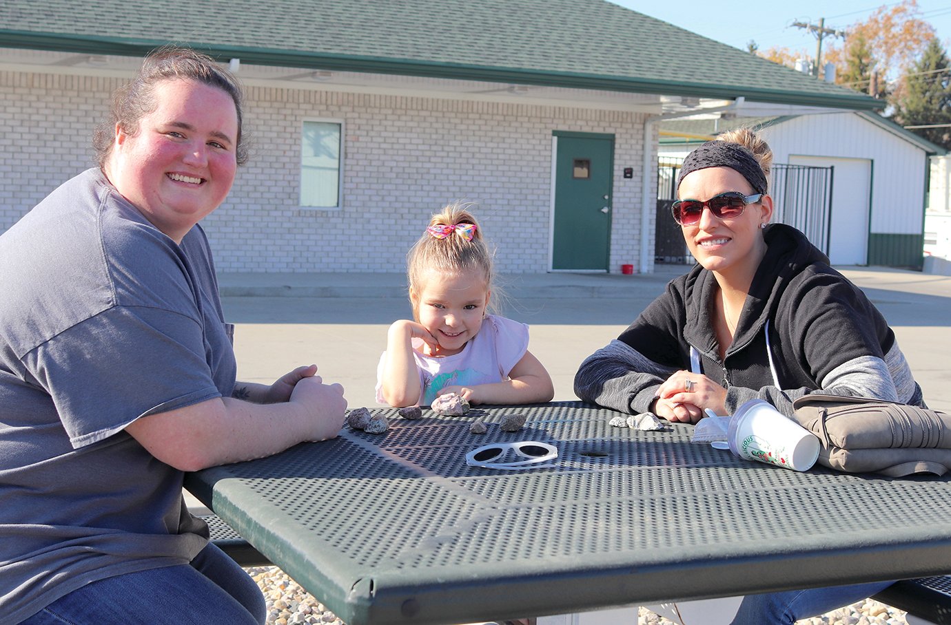 Kaylie Edwards, from left, Macey Boone, 5, and Sara Boone make the most of the warm weather Friday with some sweet treats from Dari-Licious.